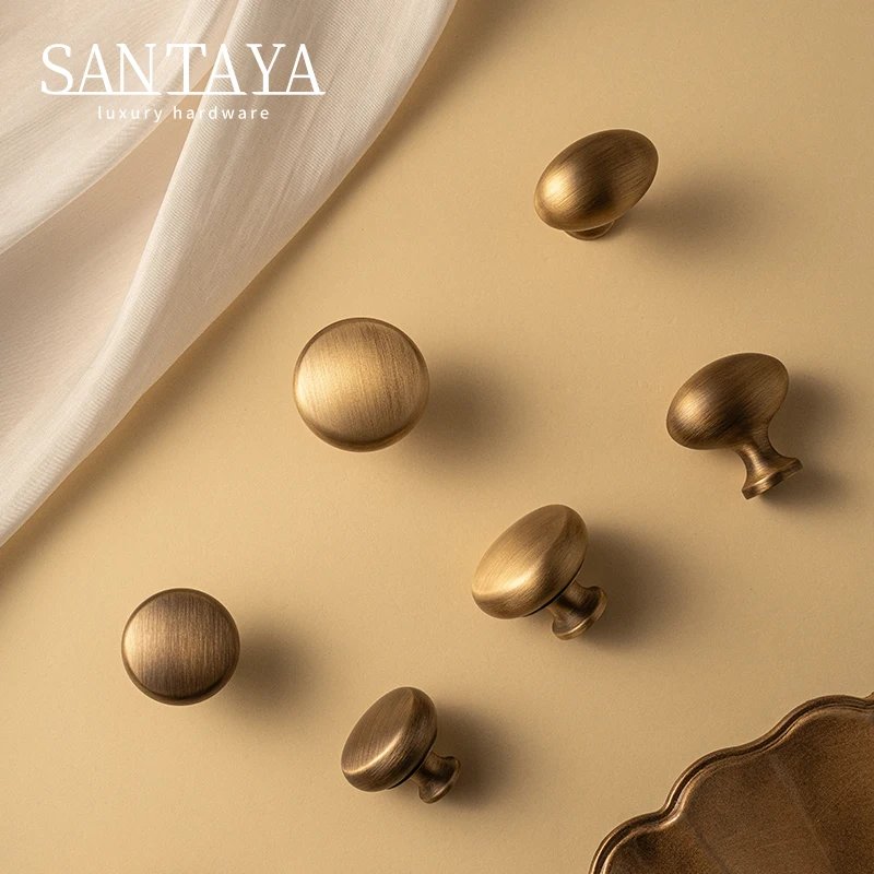 Antique brushed brass single-hole cabinet knob gallery image 1