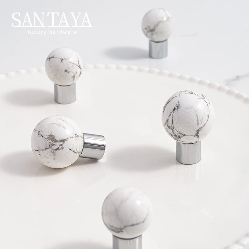 White veined round drawer knobs with silver coloured brass bases