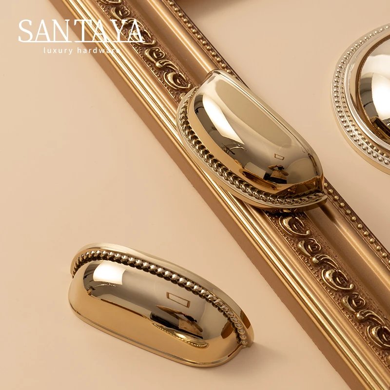 PVD gold shell cabinet pulls displayed beside a decorative frame