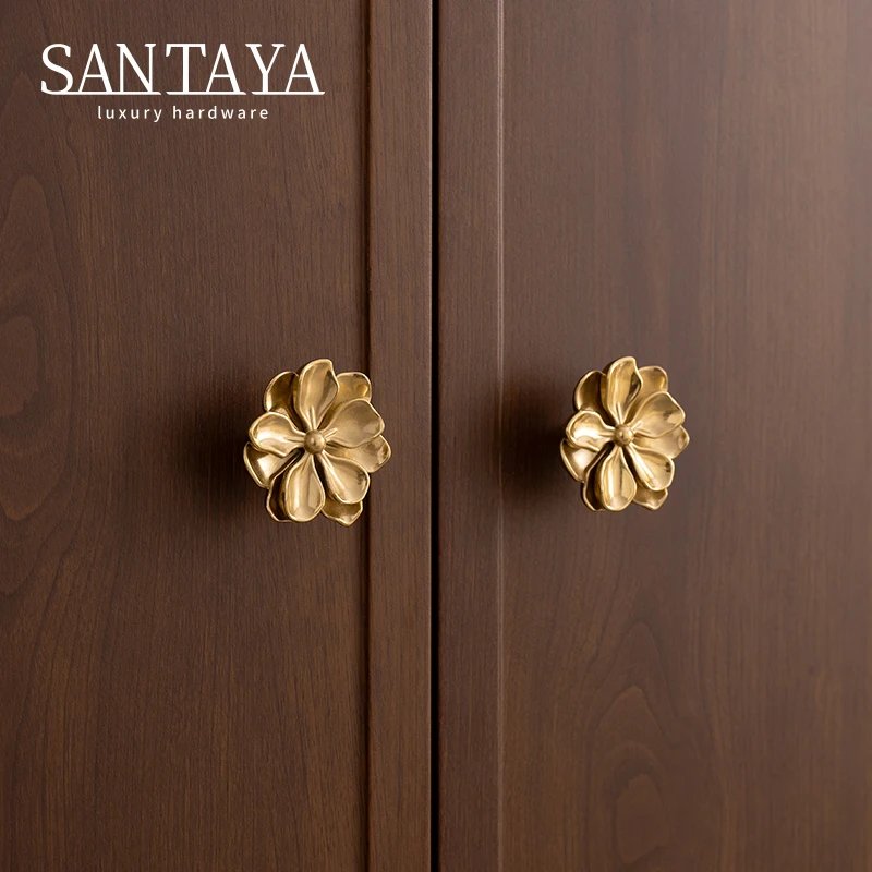 Gold camellia cabinet knobs on brown wardrobe doors