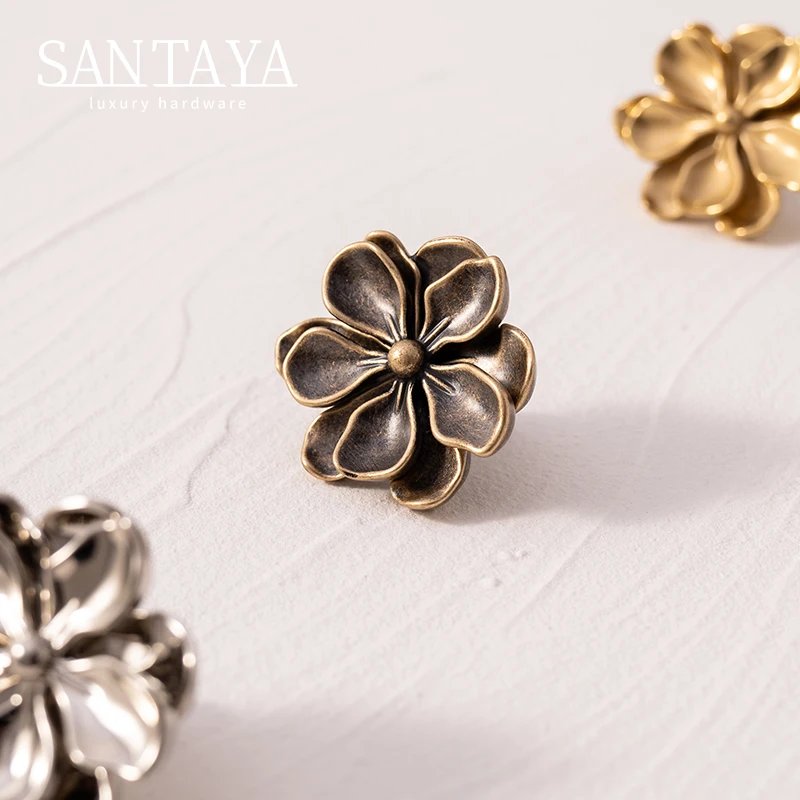 Camellia flower cabinet knobs in antique brass polished brass and silver finishes