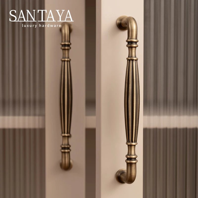 Pair of fluted brass bar pulls fitted vertically to glass cabinet doors